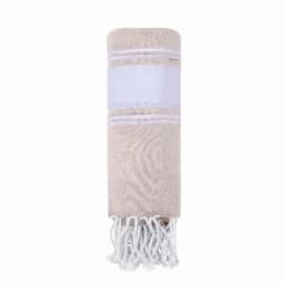 A rolled towel in beige with white fringes and a white band. It features a logo on the band.