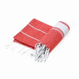 A red and white cotton towel with fringed edges, neatly rolled and partially unfolded. It features a striped pattern.