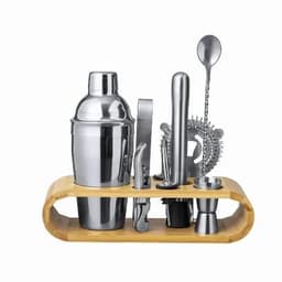 A cocktail shaker set featuring stainless steel tools on a bamboo stand, including a shaker, jigger, strainer, and spoon.