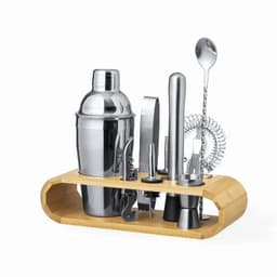 A cocktail shaker set with a polished silver finish, including various tools, displayed on a wooden stand.
