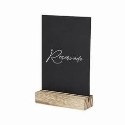A reserved sign featuring black cardstock with white script, resting in a wooden stand.