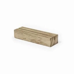 A wooden block with a smooth finish and visible grain pattern. The block is rectangular and light brown in colour.