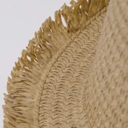 A straw hat with a textured, fringed edge, showcasing a light tan colour and woven design.