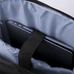 A black bag interior featuring a tablet secured with a strap against a silver lining.