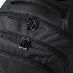 A black backpack featuring multiple zippered compartments. The zippers are black and the material appears durable.