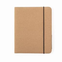 A notebook with a textured tan cover and a black elastic band, featuring no visible branding.