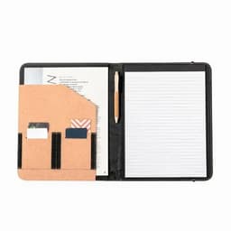 A clipboard binder featuring a cork pocket, card slots, a wooden pen, and lined paper in a black cover.
