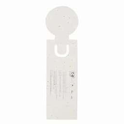 A bottle tag featuring a circular top, designed with speckles, in a light colour with a branding logo.