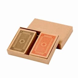 A card deck set in a brown kraft box, featuring one gold and one orange deck with intricate designs.