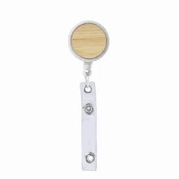 A badge holder featuring a round wooden top and a white retractable cord with a metal clip at the base.