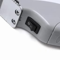A grey electronic device featuring a black on/off switch and visible screws.