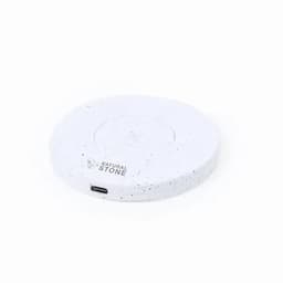A wireless charger in a circular shape, featuring a white speckled design and a small charging port.