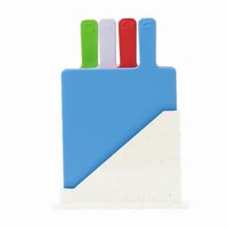 A set of colourful chopping boards in blue, green, red, and white, stored in a white stand.