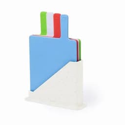 A set of cutting boards in blue, green, red, and white, displayed in a white stand.