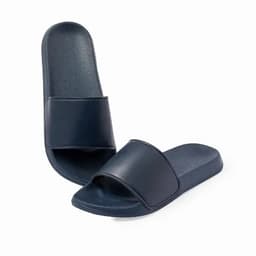 A pair of navy blue slide sandals with a simple design and a smooth finish. They have a wide strap across the top.