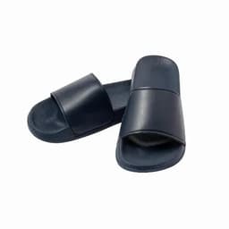 A pair of navy blue slides with a smooth upper and textured sole, featuring a simple design.