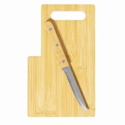 A bamboo cutting board with a serrated knife resting on it, featuring a handle cutout for easy handling.