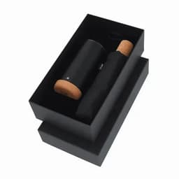 A drink bottle and lid in a sleek black gift box, featuring a cork base.