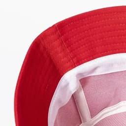 A red hat with a white inner lining and structured brim, featuring stitching detail and a logo inside.