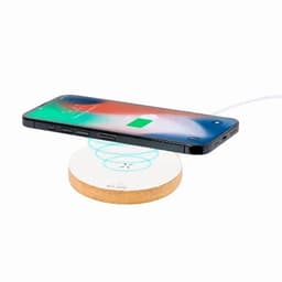 A wireless charger with a round base in a light colour, supporting a smartphone that displays a charging icon.