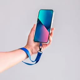 A hand holding a smartphone with a blue wrist strap, featuring a gradient screen in shades of teal and purple.