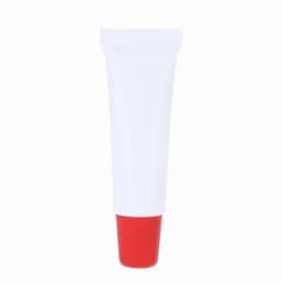 A tube of cream featuring a white body and a red cap, with a logo on the front.
