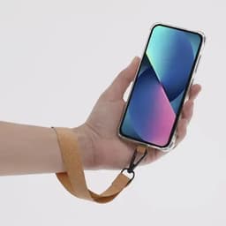 A phone case with a leather strap held in a hand, featuring a vibrant screen display. The case has a clear design.