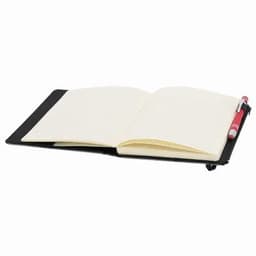 A black notebook with blank pages, open and lying flat, alongside a red pen. The notebook has a simple design.