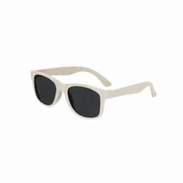 A pair of sunglasses with a light beige frame and dark lenses, featuring a textured finish.