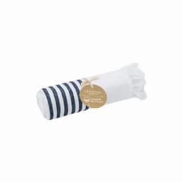 A rolled towel with navy stripes and a white section, featuring a tag and frayed edges.