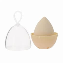 A silicone egg-shaped product in beige, accompanied by a clear protective cover.