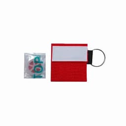 A red keychain holder with a white strip and a small packet beside it. The packet contains an item with printed text.