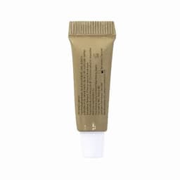 A tube of cream in a beige container with a white nozzle, featuring ingredients listed on the back.
