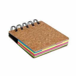 A cork-covered notebook with spiral binding, featuring brightly coloured pages in pink, green, yellow, and blue.