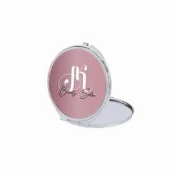 A compact mirror with a pink exterior and a silver frame, featuring a logo and the text "Beauty Salon" inside.