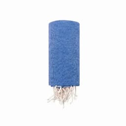 A blue towel with a textured pattern and white fringes at one end, neatly rolled up.