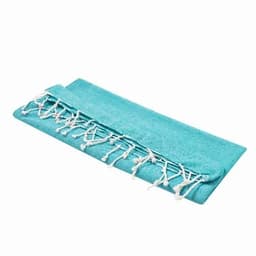 A teal towel with white fringed edges, neatly folded. It features a soft texture and a simple design.