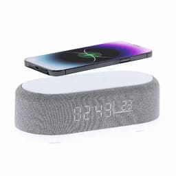 A grey smart speaker with a clock display, positioned below a smartphone featuring a vibrant screen.