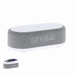 A grey and white wireless speaker with a digital clock display and a phone charging section on top.