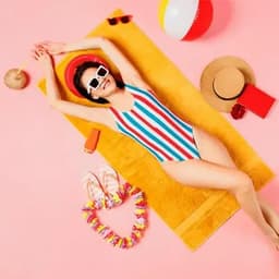 A woman in a striped swimsuit lies on a yellow towel surrounded by beach accessories, including a ball, sunglasses, and flip-flops.