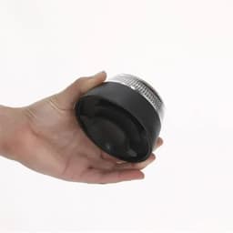 A drink bottle with a sleek black base and a transparent lid, held in a hand. The bottle features a logo.