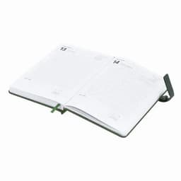 An open diary with blank pages and a green ribbon bookmark. The cover is dark green and minimalistic.