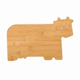 A bamboo chopping board shaped like a cow, featuring two holes for eyes. Wood tones are visible.