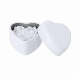 A heart-shaped container in white, partially open, revealing small white tablets inside.