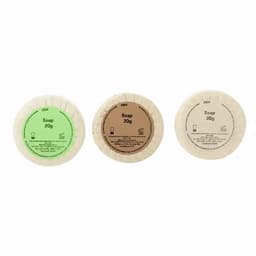 Three circular soap bars in green, brown, and a natural beige colour, each marked with 'Soap 20g' on the packaging.