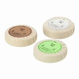 Three round bars of soap in natural packaging, each with different coloured labels: brown, green, and white.