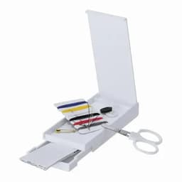 A white sewing kit featuring scissors, thread bobbins, needles, and a safety pin, all contained in a compact case.
