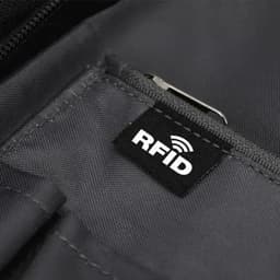 A close-up of a black fabric pocket featuring an RFID tag label. The material appears durable and textured.