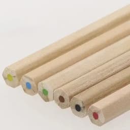 Coloured pencils in various hues, featuring bare wooden barrels and colour tips, arranged in a line.