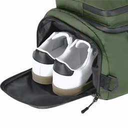 A green bag with a shoe compartment featuring a pair of white sneakers with black accents inside.
